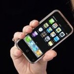 B17R2E Attractive young blond woman holding iPhone mobile phone.. Image shot 2008. Exact date unknown.